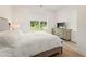 Serene bedroom with a large window and neutral decor at 10940 Serenbe Ln, Chattahoochee Hills, GA 30268