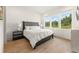 Serene bedroom with a large window offering natural light and a view of the wooded outdoors at 10940 Serenbe Ln, Chattahoochee Hills, GA 30268