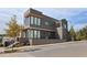 Modern home exterior boasts clean lines, expansive windows, sleek design, and a beautifully landscaped front yard at 10940 Serenbe Ln, Chattahoochee Hills, GA 30268