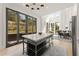 Open kitchen featuring an island, stainless steel appliances, and a seamless transition to dining area at 10940 Serenbe Ln, Chattahoochee Hills, GA 30268