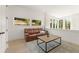 Living room with recliner seating, natural light, and hardwood floors at 10940 Serenbe Ln, Chattahoochee Hills, GA 30268
