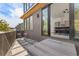 Charming outdoor patio featuring modern seating, stone pavers, and views into the kitchen with sleek finishes through sliding doors at 10940 Serenbe Ln, Chattahoochee Hills, GA 30268