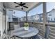 Relaxing covered balcony with outdoor seating and ceiling fan, offering a perfect spot to unwind at 2225 Nena Way, Tucker, GA 30084
