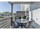Charming covered balcony offering a relaxing space for outdoor enjoyment with a table and chairs set at 2225 Nena Way, Tucker, GA 30084
