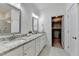 Bathroom featuring a double vanity, walk-in shower, and access to a walk-in closet at 2225 Nena Way, Tucker, GA 30084