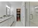 Bathroom featuring a double vanity, walk-in shower, and access to a walk-in closet at 2225 Nena Way, Tucker, GA 30084