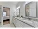 Bright bathroom featuring a double sink vanity with granite countertops and modern fixtures at 2225 Nena Way, Tucker, GA 30084