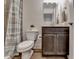 Cozy bathroom featuring a toilet, vanity with sink, and shower with a stylish curtain at 2225 Nena Way, Tucker, GA 30084