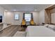 Bedroom with a murphy bed, wood floor, door to the outside, and a window with yellow chairs at 2225 Nena Way, Tucker, GA 30084