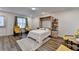 Inviting bedroom with wood floors, a Murphy bed and seating area, creating a perfect retreat at 2225 Nena Way, Tucker, GA 30084
