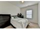 Relaxing bedroom featuring a bed, large window and study desk with a dark-colored design at 2225 Nena Way, Tucker, GA 30084