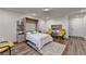 Bright, comfortable bedroom with wood floors, a Murphy bed, and comfortable seating area at 2225 Nena Way, Tucker, GA 30084