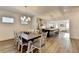 Open-concept dining room leads to a modern kitchen and living area with a dining table for eight at 2225 Nena Way, Tucker, GA 30084