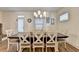 Spacious dining room with a modern chandelier, with seating for six at 2225 Nena Way, Tucker, GA 30084