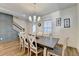 Bright dining room with modern chandelier, wood floors, and wainscoting at 2225 Nena Way, Tucker, GA 30084