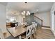 Dining room leading to a modern kitchen and stairway with dining table for eight guests at 2225 Nena Way, Tucker, GA 30084
