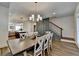 Dining room leading to a modern kitchen and stairway with dining table for eight guests at 2225 Nena Way, Tucker, GA 30084