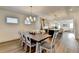 Open-concept dining room leads to a modern kitchen and living area with dining table for eight at 2225 Nena Way, Tucker, GA 30084