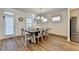 Bright dining room featuring a modern light fixture and an expansive dining table with seating for eight at 2225 Nena Way, Tucker, GA 30084