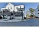 Exterior view of modern townhomes with private balconies, garages, and well-maintained landscaping at 2225 Nena Way, Tucker, GA 30084
