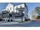 Exterior view of modern townhomes with private balconies, garages, and well-maintained landscaping at 2225 Nena Way, Tucker, GA 30084
