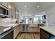 Open-concept kitchen with stainless steel appliances and a farmhouse sink overlooking the living area at 2225 Nena Way, Tucker, GA 30084