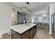 Stylish kitchen island with quartz countertop, dark cabinets, and modern light fixture at 2225 Nena Way, Tucker, GA 30084