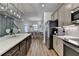 Modern kitchen features stainless steel appliances, island with white countertop, and wood-look flooring at 2225 Nena Way, Tucker, GA 30084