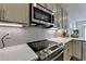 Close-up of a kitchen with stainless steel appliances and white subway tile backsplash at 2225 Nena Way, Tucker, GA 30084