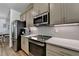 Modern kitchen with stainless steel appliances and neutral cabinets at 2225 Nena Way, Tucker, GA 30084