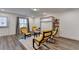 Stylish living room with wood floors, yellow chairs, and a built in Murphy bed for flexible living at 2225 Nena Way, Tucker, GA 30084