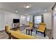 Bright, modern living room with wood floors, comfortable yellow chairs and convenient access to the outdoors at 2225 Nena Way, Tucker, GA 30084