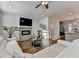 Bright living room featuring modern fireplace, tv, hardwood floors, and white sofa at 2225 Nena Way, Tucker, GA 30084
