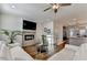 Bright living room featuring modern fireplace, tv, hardwood floors, and white sofa at 2225 Nena Way, Tucker, GA 30084