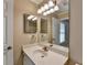 Bright bathroom with a single vanity, decorative lighting, and a large mirror at 30 Plantation Ne Dr # B, Atlanta, GA 30324