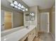 Bathroom vanity with a large mirror and decorative lighting fixtures at 30 Plantation Ne Dr # B, Atlanta, GA 30324