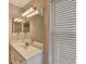 Bathroom with a single vanity, decorative lighting, and a large mirror at 30 Plantation Ne Dr # B, Atlanta, GA 30324