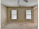 This carpeted bedroom features neutral walls and two windows with blinds at 30 Plantation Ne Dr # B, Atlanta, GA 30324