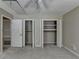 Neutral bedroom featuring carpet, a ceiling fan, and two closets with white doors at 30 Plantation Ne Dr # B, Atlanta, GA 30324