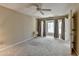 Spacious bedroom with a ceiling fan, neutral walls, and a large window with natural light at 30 Plantation Ne Dr # B, Atlanta, GA 30324
