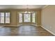 Bright dining room features large bay windows and wood floors, creating a welcoming atmosphere at 30 Plantation Ne Dr # B, Atlanta, GA 30324