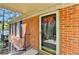 Close-up of a brick entryway with a storm door featuring a wreath on the glass at 30 Plantation Ne Dr # B, Atlanta, GA 30324