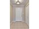Foyer features neutral walls, tiled floor, overhead light fixture and white front door and closet at 30 Plantation Ne Dr # B, Atlanta, GA 30324