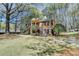 Classic brick home nestled amongst mature trees, featuring a covered entry and dual staircases at 30 Plantation Ne Dr # B, Atlanta, GA 30324