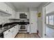 Fully equipped kitchen boasting stainless steel appliances, black countertops, and seamless access to other rooms at 30 Plantation Ne Dr # B, Atlanta, GA 30324