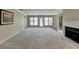 Open living room with a fireplace, access to a balcony, and seamless flow into the dining area at 30 Plantation Ne Dr # B, Atlanta, GA 30324