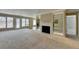 Bright living room featuring a fireplace, mirrored shelving, and access to an outdoor balcony at 30 Plantation Ne Dr # B, Atlanta, GA 30324