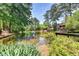 Scenic pond view with lush landscaping, fountain, and adjacent building at 30 Plantation Ne Dr # B, Atlanta, GA 30324