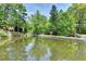 Beautiful pond surrounded by mature trees and greenery with nearby apartments at 30 Plantation Ne Dr # B, Atlanta, GA 30324