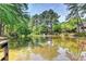 Reflective pond surrounded by lush trees offering a tranquil view at 30 Plantation Ne Dr # B, Atlanta, GA 30324